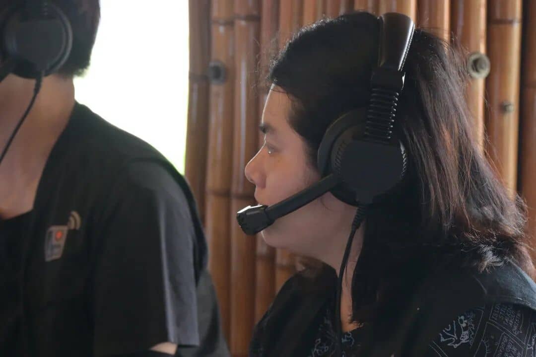 XinChuan Studio livestream team member communicating through a headset